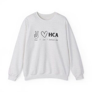 Paz amor HCA Asistente de atención médica Sudadera unisex Heavy Blend™ Crewneck