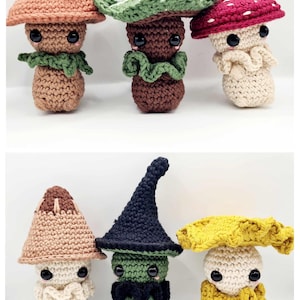 May include: Set of six crocheted mushroom plushies. The mushrooms are in various colours, including brown, green, red, yellow, and white. Each mushroom has a unique hat or cap, and some have facial features like eyes and a moustache.