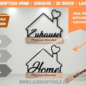 Puede incluir: Letreros decorativos para el hogar de madera cortada con láser, negros. Uno dice "Zuhause" y el otro "Home", ambos con un corazón encima de la chimenea. Los letreros están montados sobre una base de madera. La imagen también muestra formatos de archivos digitales.