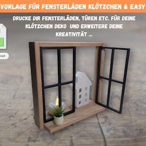 May include: A wooden window-shaped shelf with black window frames and a small white house. A small potted plant and a candle are on the shelf. The text "3D STL VORLAGE FÜR FENSTERLÄDEN KLÖTZCHEN & EASY STICKS" is at the top.
