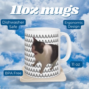 May include: White ceramic mug with a black and white cat image. The mug has a black repeating pattern of the letter 'A' on the side. The mug is 11 ounces and has an ergonomic design. It is dishwasher safe and BPA free.