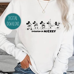May include: White sweatshirt with a black and white graphic of the evolution of Mickey Mouse. The graphic shows Mickey Mouse in different stages of his design, from his earliest appearance to his modern look. The text "Evolution of Mickey" is printed below the graphic.