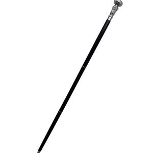 May include: A black walking cane with a decorative silver-colored handle. The handle has a detailed design, and the cane has a sleek, polished appearance. The cane is a classic accessory.