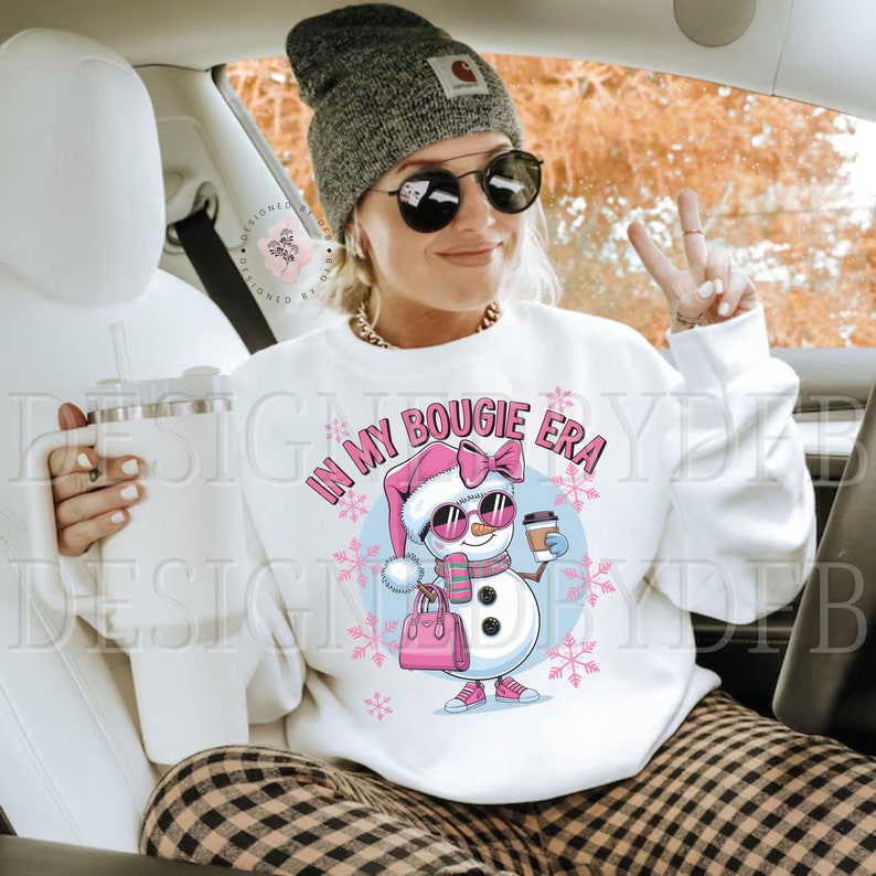 May include: White sweatshirt with a pink and blue snowman graphic and the text "In My Bougie Era".