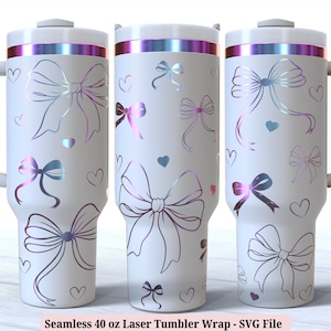 May include: Three white 1183 ml tumblers with a handle, decorated with iridescent bows and hearts. The tumblers have a white lid and handle. The text "Seamless 40 oz Laser Tumbler Wrap - SVG File" is at the bottom.