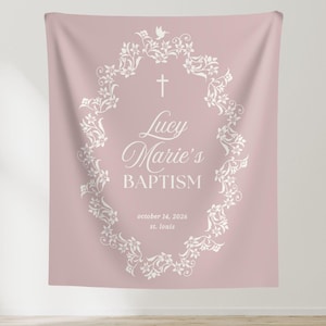 May include: A pink fabric backdrop with a white floral design and the text "Lucy Marie's Baptism" with the date "october 14, 2026" and the location "st. louis".