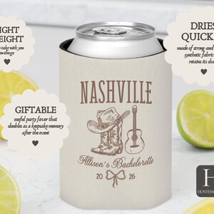 May include: A beige can cooler with the word "NASHVILLE" in brown text, along with a cowboy hat, boots, and guitar illustration. The text "Allison's Bachelorette 2026" is also present. The cooler is surrounded by lemon and lime slices.