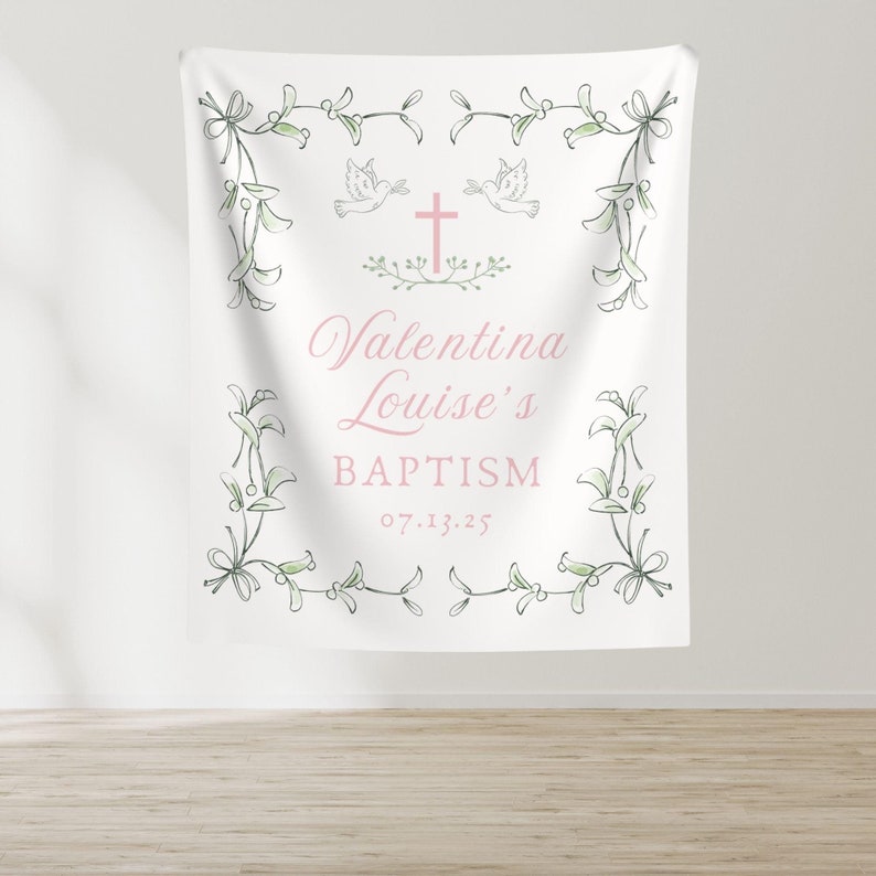 May include: White baptism banner with a green floral border and a pink cross with two doves. The text reads "Valentina Louise's Baptism 07.13.25".