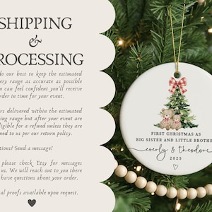 May include: A white ceramic Christmas ornament with a watercolor design of a Christmas tree, two teddy bears, and a red and white plaid bow. The text reads "First Christmas as Big Sister and Little Brother" with names and the year 2025.