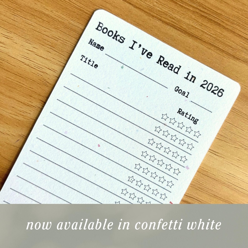 May include: A white, confetti-speckled book tracker card with the text "Books I've Read in 2026." It includes spaces for name, title, goal, and a rating system with stars. The bottom of the card reads "now available in confetti white."