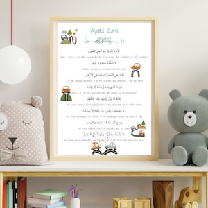 May include: A white framed print with a green and brown illustration of cars and a road. The print features the Arabic text "Ayatul Kursi" and a translation of the text in English.