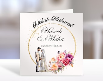 May include: A white card with gold glitter and a gold circle around the text "Nikkah Mubarak Haseeb & Maha October 14th 2023". A watercolor floral design with pink, purple, and orange flowers is below the text. A cartoon image of a couple in traditional clothing is in the center of the circle.