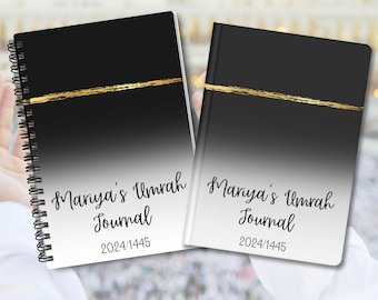 May include: Two journals with a black and white gradient design and a gold stripe. The text "Mariya's Umrah Journal" and the year "2024/1445" are printed on the cover. One journal has a spiral binding.