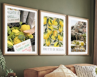 May include: A living room with a brown leather sectional sofa, three framed prints on the wall, and a wooden coffee table. The prints feature lemons, a cityscape, and a market scene. The sofa has a throw blanket and pillows in various patterns and colors.