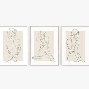 May include: Set of three minimalist line art prints featuring a woman in different poses. Each print has a beige background and a black line drawing of a woman.