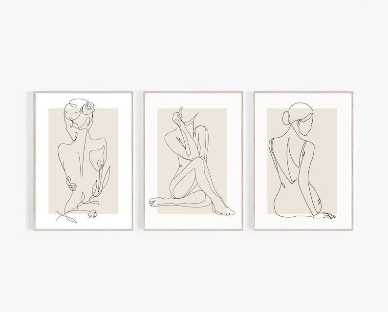 May include: Set of three minimalist line art prints featuring a woman in different poses. Each print has a beige background and a black line drawing of a woman.