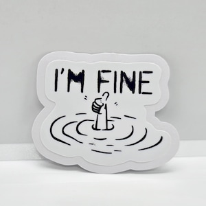 May include: White sticker with black text and a drawing of a hand giving a thumbs up, partially submerged in water. The text reads "I'm Fine."
