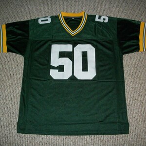 May include: Green and yellow football jersey with the number 50 on the front.