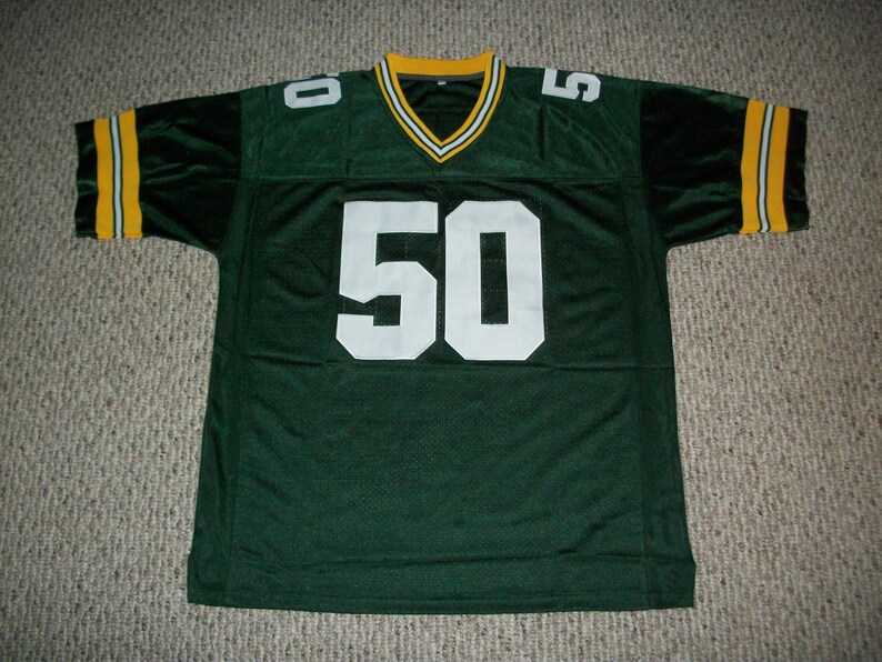 May include: Green and yellow football jersey with the number 50 on the front.