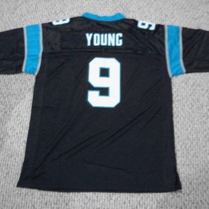 May include: Black football jersey with blue and gray trim. The jersey has the number "9" and the name "YOUNG" on the back.
