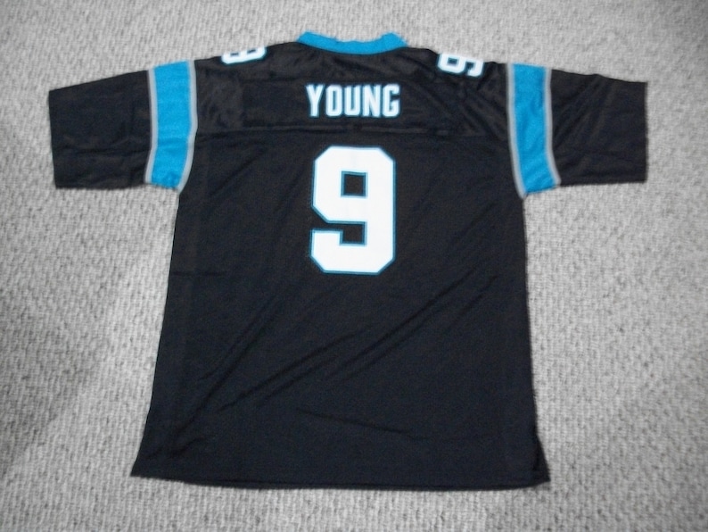 May include: Black football jersey with blue and gray trim. The jersey has the number "9" and the name "YOUNG" on the back.