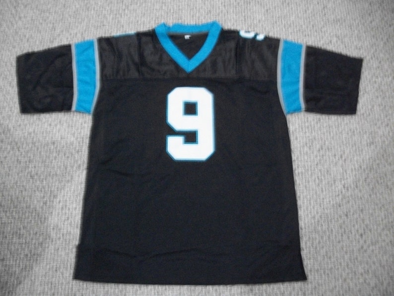 May include: Black football jersey with blue and gray trim. The number 9 is printed in white on the front of the jersey.