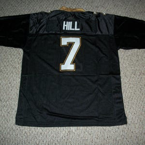 May include: Black football jersey with gold trim and the name "HILL" and number "7" on the back.