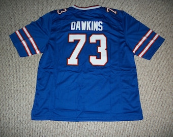 Camiseta personalizada cosida de Dion Dawkins #73, color azul búfalo, disponible en todas las tallas para adultos.