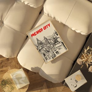 May include: A framed black and white line drawing of the Mexico City skyline with the text "MEXICO CITY" in red letters at the top of the frame.