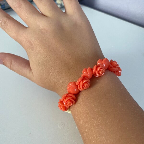 Cream colored bracelet with peachy red roses