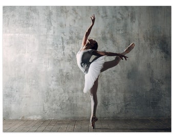May include: A ballerina in a white tutu and pointe shoes performs a graceful pose against a textured grey wall. Her arm is extended overhead, and her leg is extended to the side. The wooden floor adds a warm contrast.