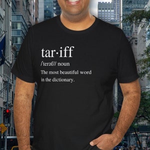 May include: Black t-shirt with white text that reads "tar-iff /terǝf// noun The most beautiful word in the dictionary."