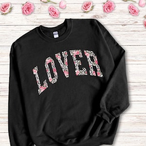 May include: Black sweatshirt with a floral and leopard print "LOVER" graphic.