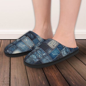 May include: A pair of blue denim patchwork slippers with a black sole. The slippers are made of different pieces of denim fabric sewn together.