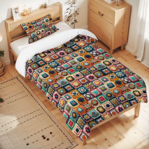 May include: A bed with a colorful patchwork quilt and matching pillow. The quilt features a repeating pattern of squares in shades of blue, orange, pink, and green. The bed frame is made of light-colored wood.