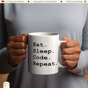 May include: White ceramic mug with black text that reads "Eat. Sleep. Code. Repeat."