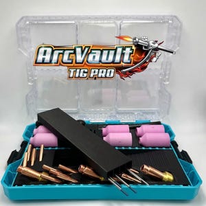 May include: A clear plastic toolbox with the text "ArcVault TIG PRO" contains welding supplies. The box is teal and black, with pink and copper-colored components. The lid is clear, and the box is open, displaying the contents.