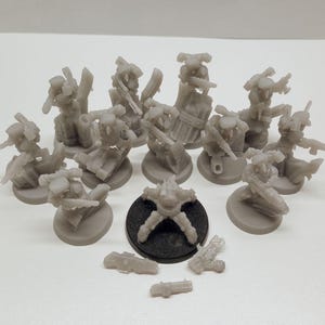 May include: A set of 10 gray plastic miniature figures, some with weapons, standing on round bases. There is a gray plastic spider-like figure in the center of the image, and two gray plastic weapons on the bottom of the image.