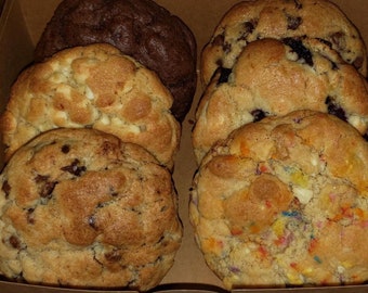 May include: A box of six assorted cookies, including chocolate chip, white chocolate chip, and a sprinkle cookie.