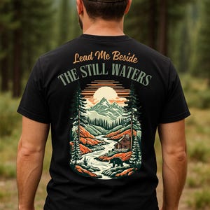 Lead Me Beside The Still Waters T-Shirt – Christian Mountain Scene Tee | Psalm 23 Shirt | Nature Faith Graphic Tee | Bible Verse Shirt