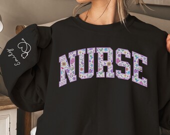 May include: Black sweatshirt with a floral design spelling out the word "NURSE".