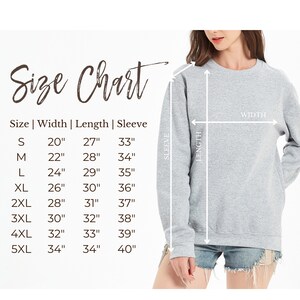 May include: A light gray sweatshirt with a size chart. The size chart shows measurements for width, length, and sleeve length in inches. The sweatshirt is being modeled, with arrows indicating the width and length measurements.