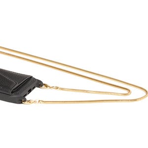 May include: A gold chain phone strap with a black phone case attached. The chain is a snake chain style.