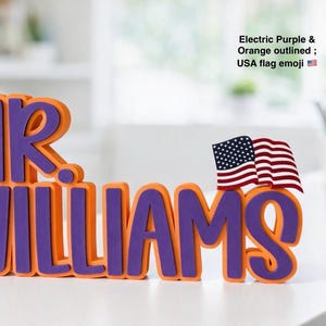 Puede incluir: Un letrero con nombre personalizado que muestra el texto MR. WILLIAMS en letras moradas el&eacute;ctricas en negrita con un borde naranja grueso. Una peque&ntilde;a bandera estadounidense tridimensional est&aacute; unida a la parte superior derecha de la letra S.