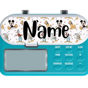 May include: A teal medical device with a white top featuring Mickey Mouse, Donald Duck, and Pluto. The word "Name" is printed in black. The device has buttons labeled "ON/OFF", "FEED INT", "CLEAR", "PRIME", "VOL/TOTAL", "+", "RUN/PAUSE", "RATE/DOSE", and "-".
