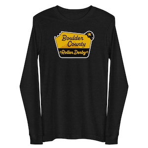 May include: Black long-sleeve shirt with a yellow and black graphic of a sign that says "Boulder County Roller Derby".