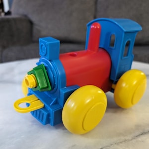 Train doll tupperware top