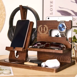 May include: A wooden organizer with a phone stand, headphone holder, watch stand, and a small shelf for glasses or other items. The organizer is personalized with the name "Hamilton" and a monogram "H".