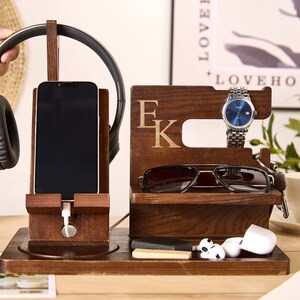 May include: Wooden organizer with compartments for a phone, headphones, watch, sunglasses, and other small items. The organizer is personalized with the initials "E K".