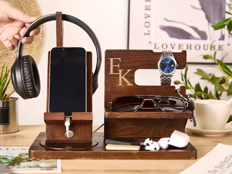 May include: Wooden organizer with compartments for a phone, headphones, watch, sunglasses, and other small items. The organizer is personalized with the initials "E K".